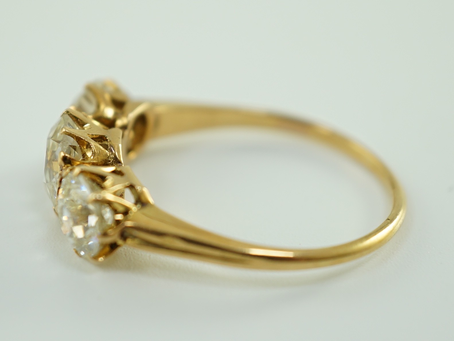 A gold and three stone diamond ring